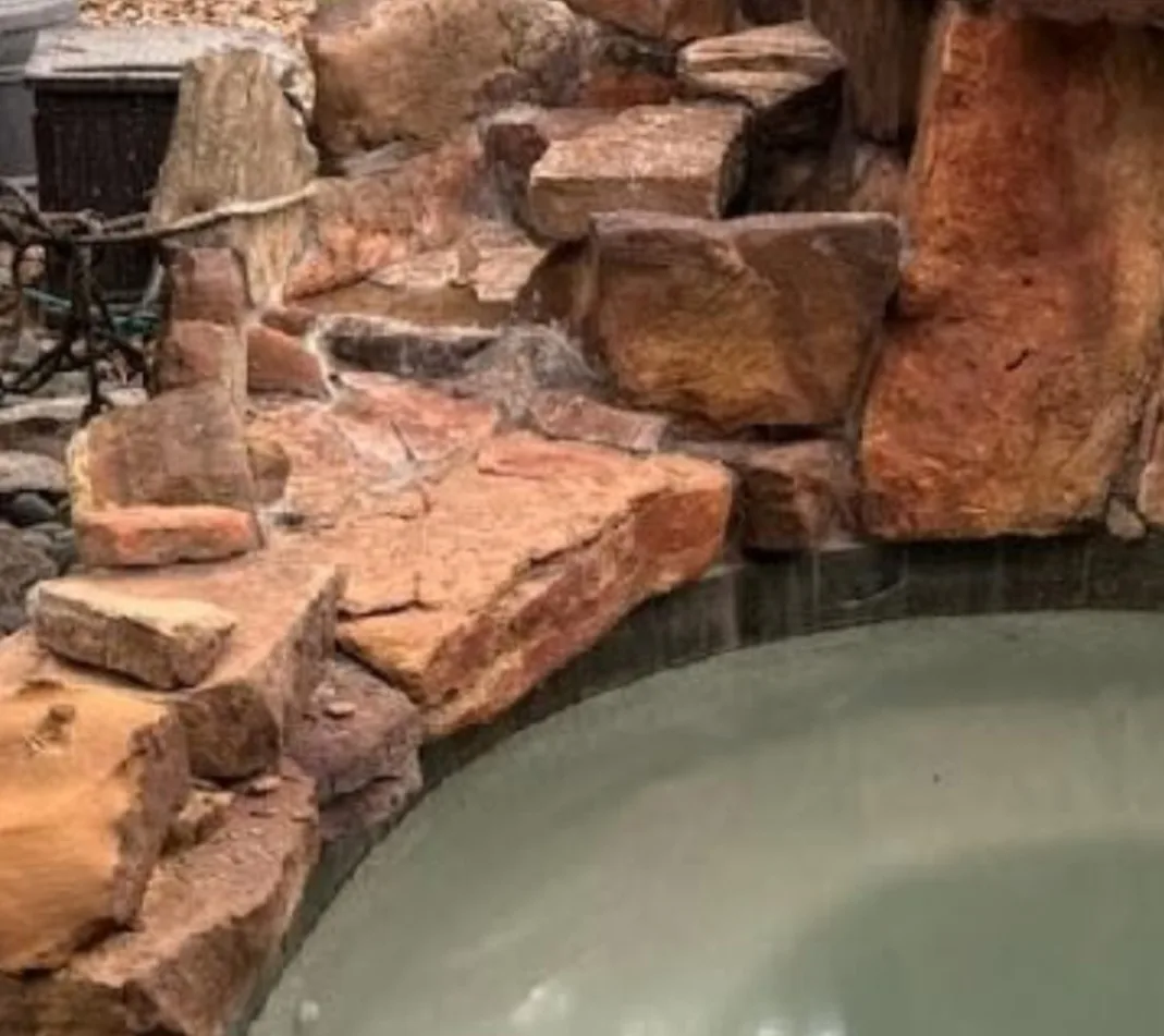Pool rock waterfall restored to natural stone color after bead blasting by Redzone Pools